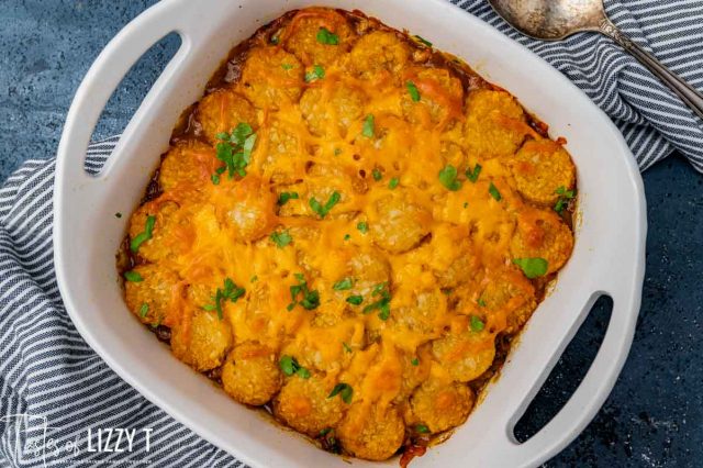 baked tater tot casserole with fresh parsley on top