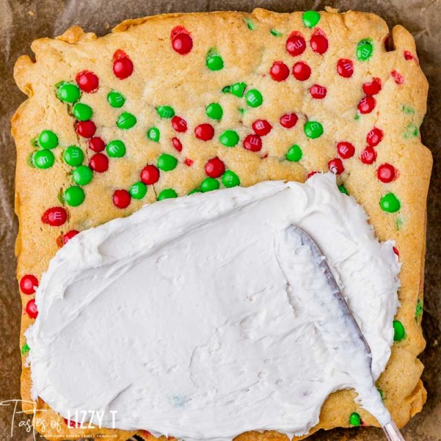 frosting spreading over sugar cookie bars