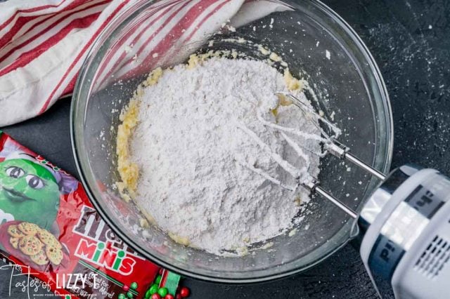 flour over creamed butter in a mixing bowl