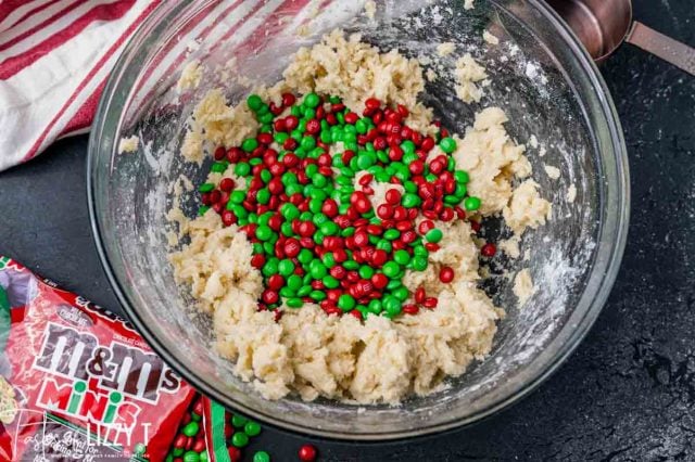 m&ms over cookie dough in a bowl