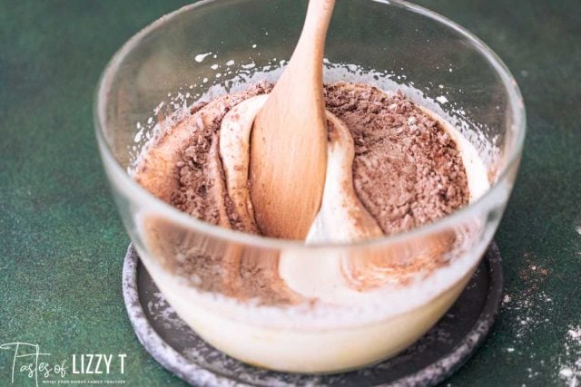 dry ingredients mixing into wet ingredients in a bowl