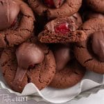 a plate full of chocolate covered cherry cookies