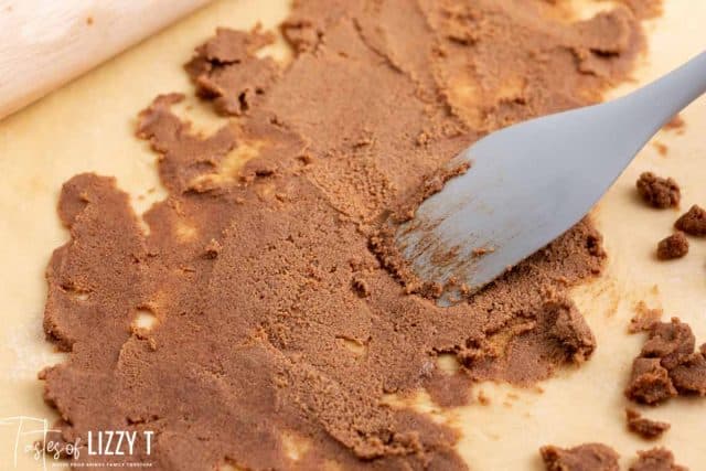 spreading cinnamon filling over dough