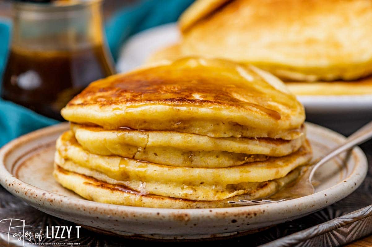 4 pancakes on a plate with a fork