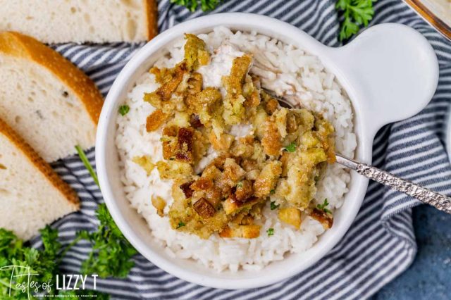 a bowl of rice with chicken and stuffing over it