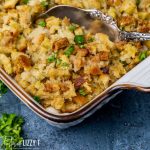 stuffing casserole with a serving spoon