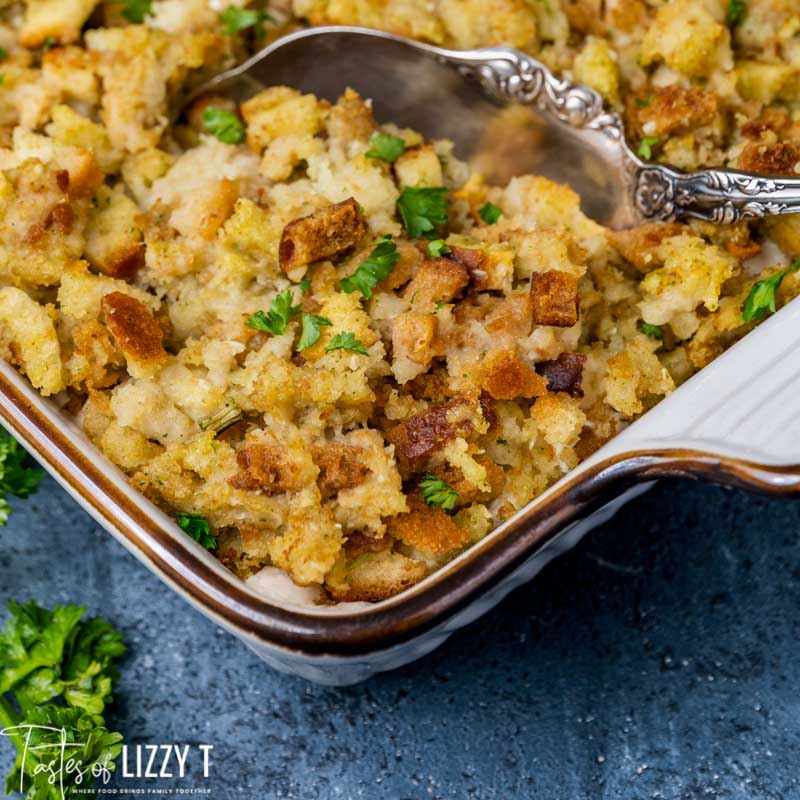 stuffing casserole with a serving spoon