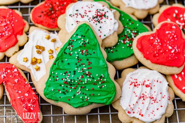 closeup of frosted cut out cookies on a wire rack