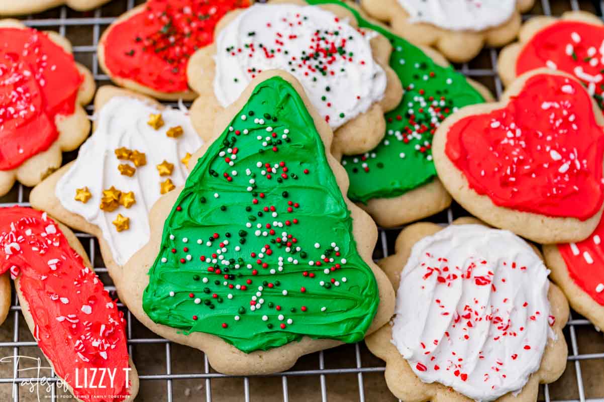 closeup of frosted cut out cookies on a wire rack