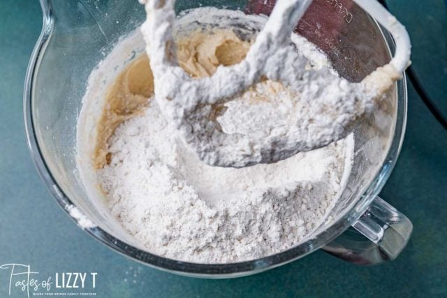 flour over wet ingredients in a mixing bowl