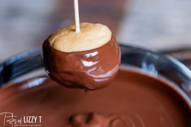 dipping a buckeye in chocolate