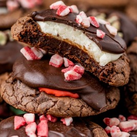 half of a peppermint brownie cookie on top of other cookies