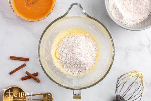 flour over wet ingredients in a mixing bowl