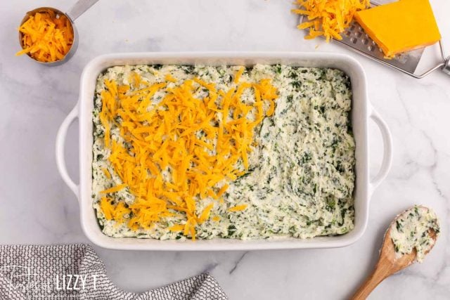 spinach mashed potatoes topped with cheddar cheese