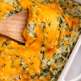 cheesy spinach mashed potatoes with a wooden spoon