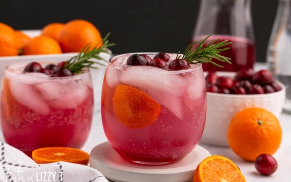 two glasses of cranberry orange punch on a table