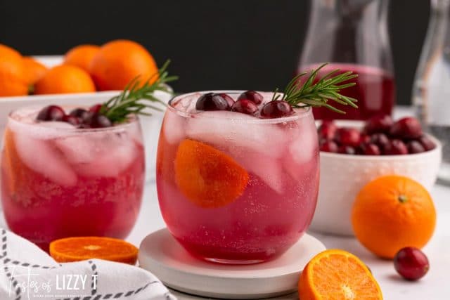 two glasses of cranberry orange punch on a table