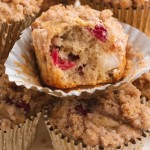 a pile of muffins with cranberries and pears