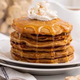 ginger spice pancakes with syrup and whipped cream