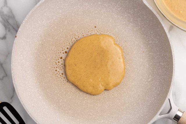 a pancake cooking in a skillet