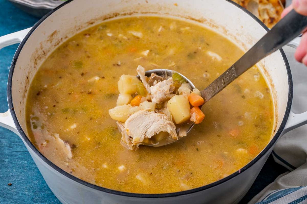 a pot of chicken potato soup with carrots