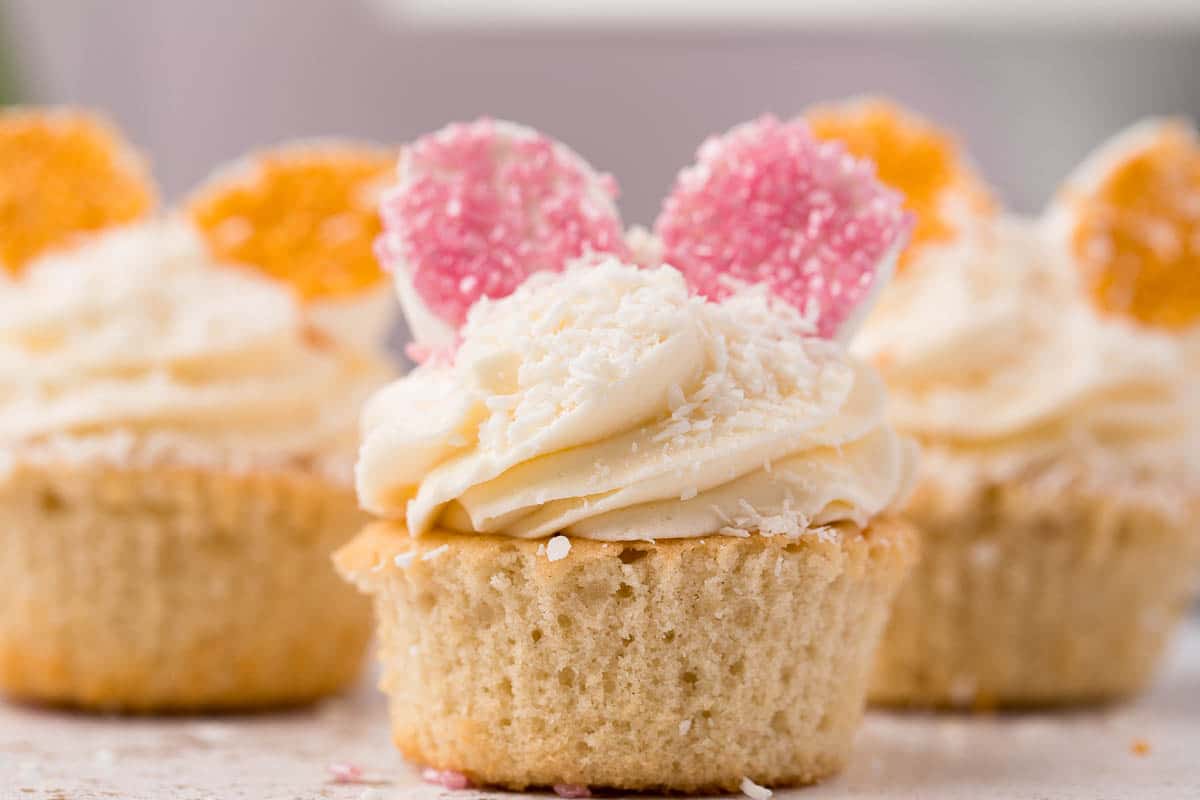closeup of of a orange vanilla cupcake with bunny ears