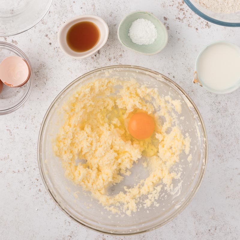 creamed butter and sugar with an egg on top in a bowl