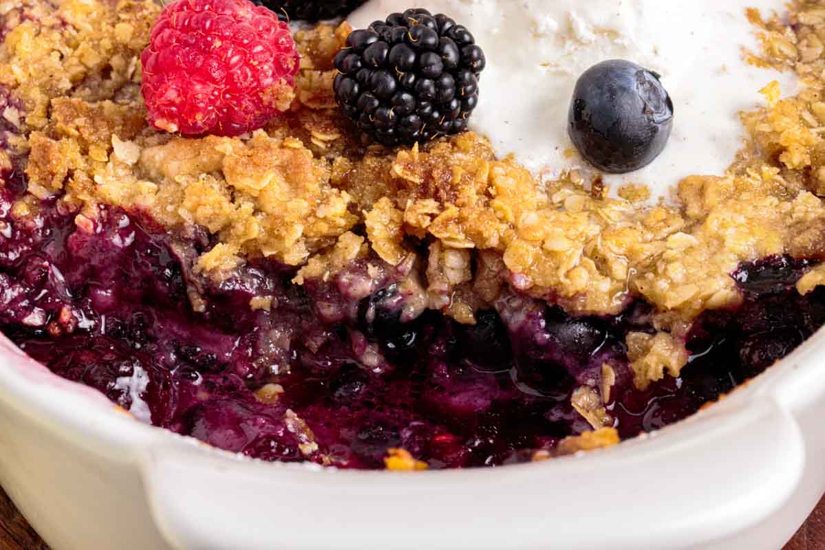 closeup of triple berry fruit crisp in a baking pan