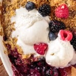 overhead view of mixed berry fruit crisp with ice cream on top