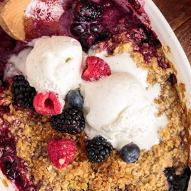 closeup of mixed berry crisp with ice cream