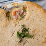 a spoon cutting into ham pot pie