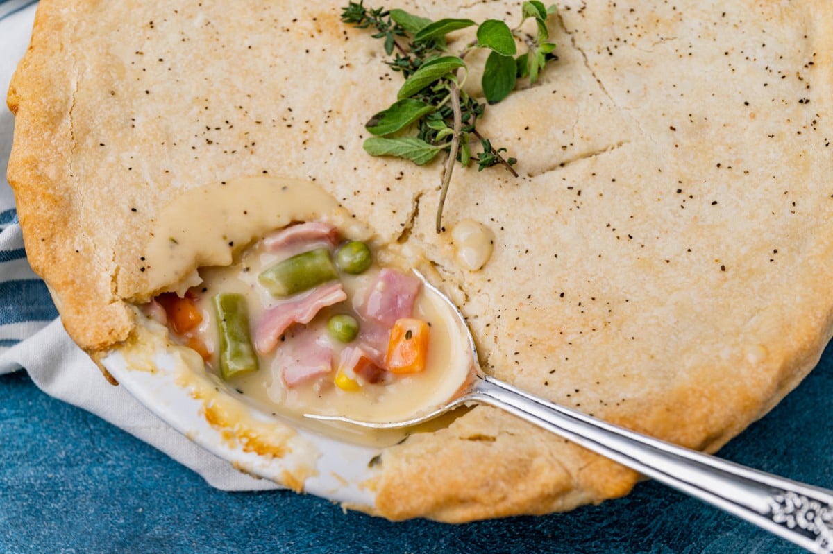 closeup of a spoonful of ham pot pie with veggies