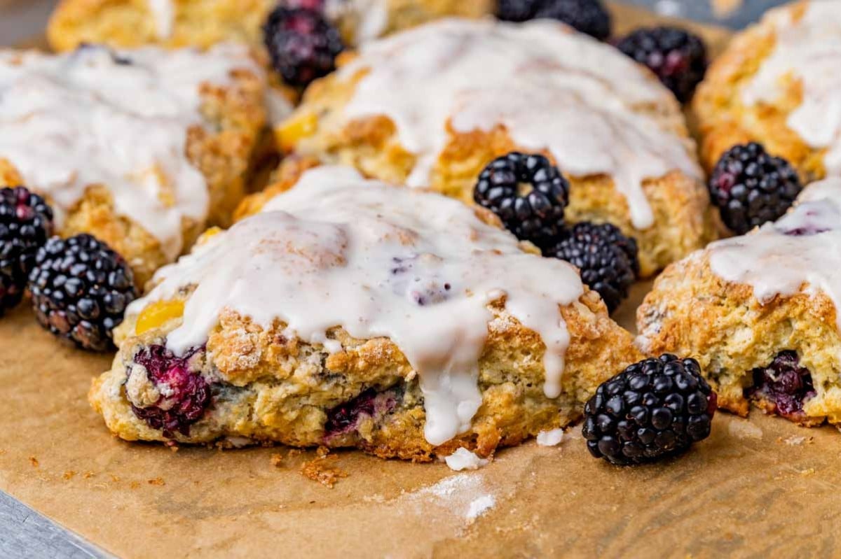 glazed scones with blackberries on a pan