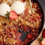 overhead view of strawberry crisp with ice cream