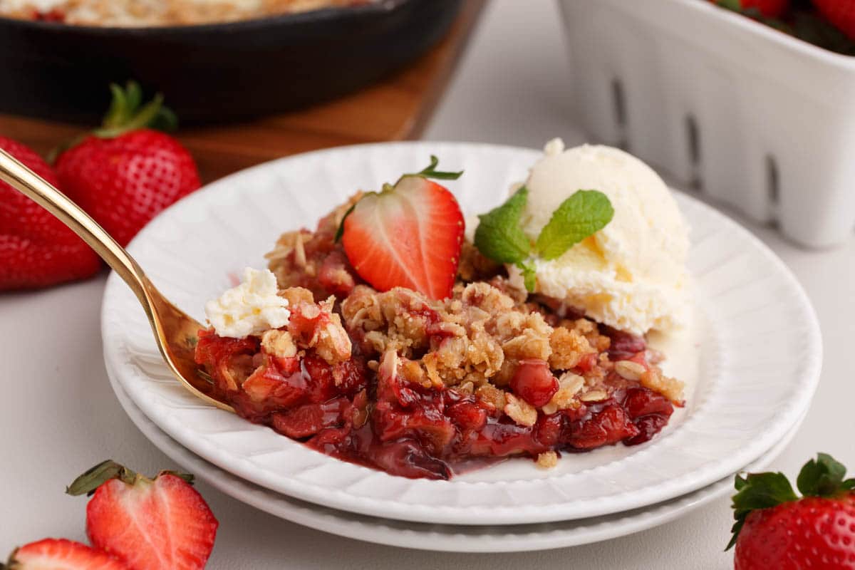 strawberry crisp on a plate with a spoon