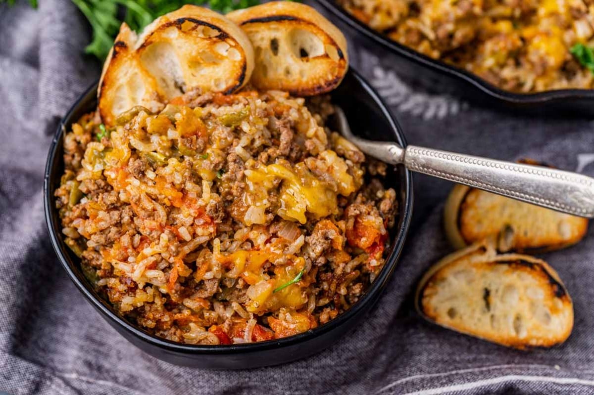 a bowl of texas hash with slices of bread