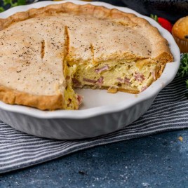 easter ham pie in a pie plate with a slice missing