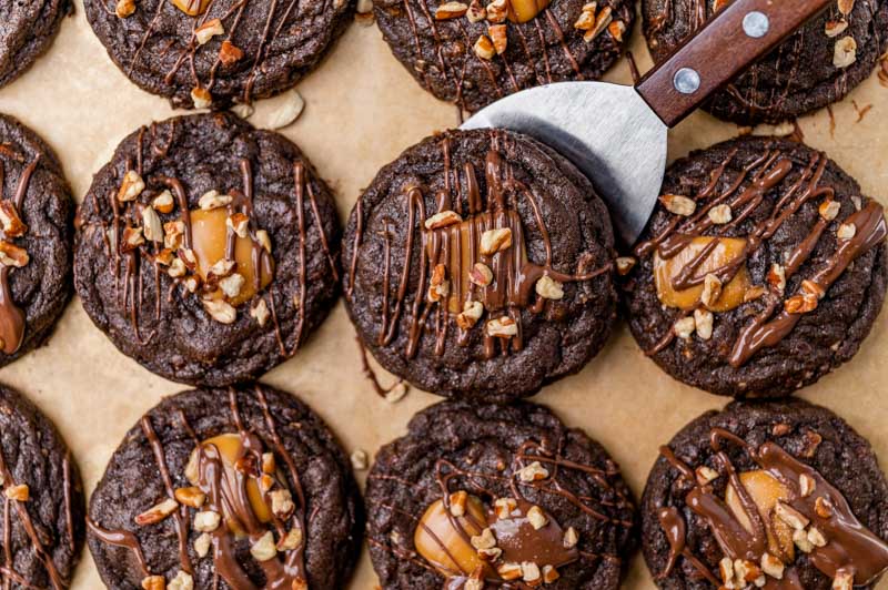 double chocolate cookies on a baking sheet with a spatula