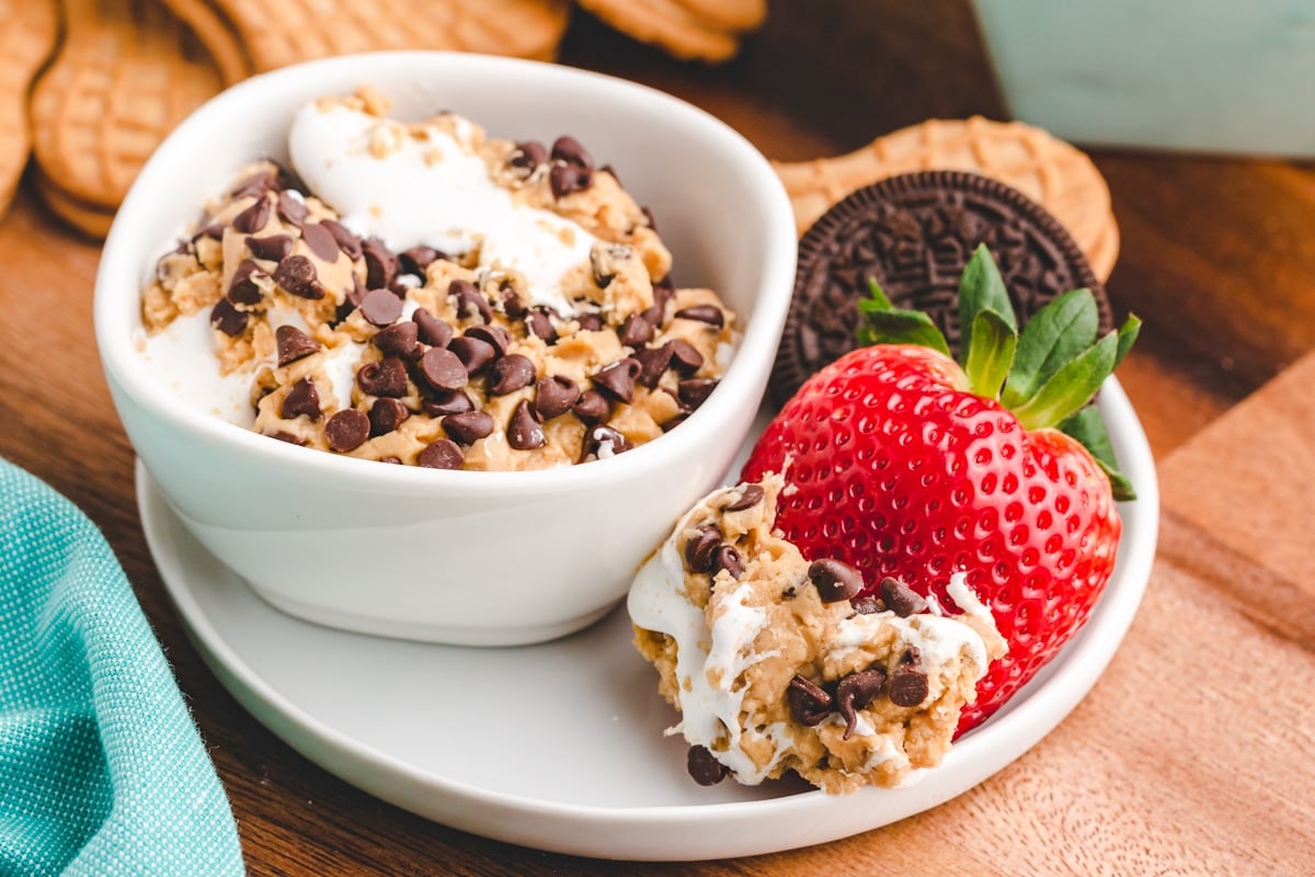 chocolate peanut butter dessert dip in a bowl with fruit and cookies