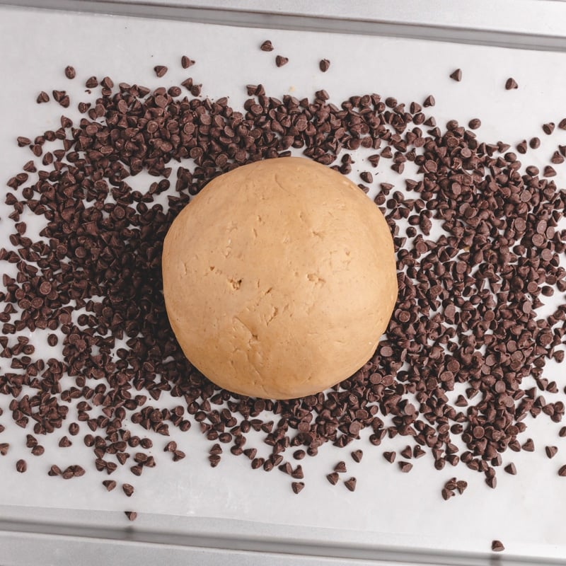 peanut butter ball on a pan with mini chocolate chips