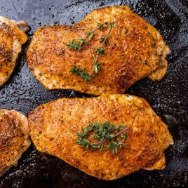 overhead view of pork chops in a skillet