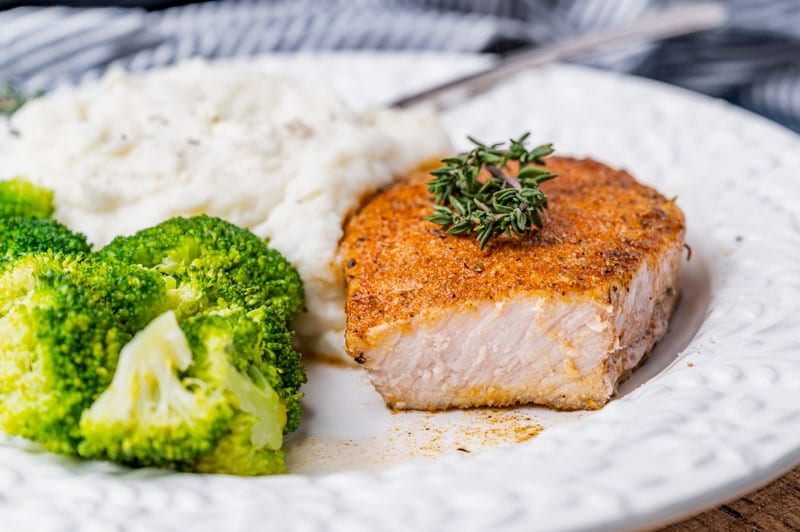 pork chops, potatoes and broccoli on a plate