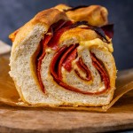 closeup of the inside of a loaf of pepperoni cheese bread