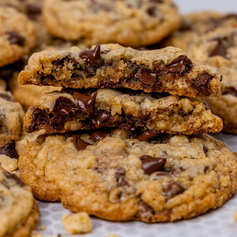 a chocolate chip cookie broken in half on a table