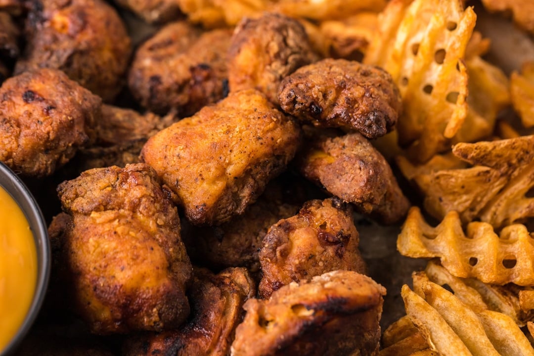 a pile of chicken nuggets and waffle fries