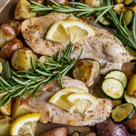 lemon chicken with potatoes and zucchini on a pan