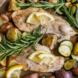 lemon chicken with potatoes and zucchini on a pan