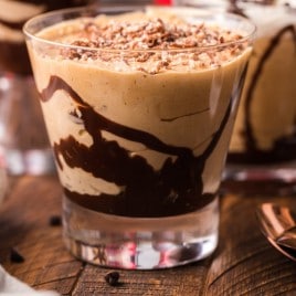 a glass cup with peanut butter mousse and chocolate