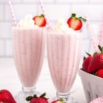 two glasses of strawberry milkshakes