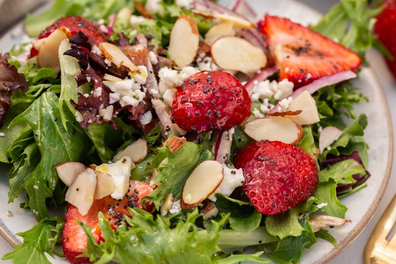 a plate of strawberry spinach salad